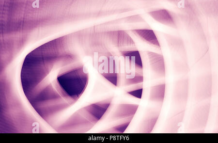 Abstract background made by zooming and rotating camera pointed at city lights at night. Stock Photo