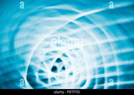 Abstract background made by zooming and rotating camera pointed at city lights at night. Stock Photo