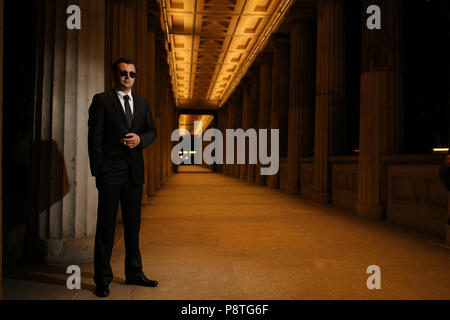 Man in black suit, secret agent, secret service police agent Stock Photo