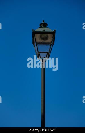 vintage dark green street lamp with a blue sky background Stock Photo
