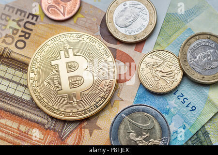 Calais, France - 17 June 2018: Bitcoin physical coin and Euro coins sitting on Euro banknotes Stock Photo