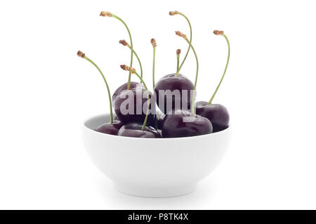 White cup with dark cherries. On a white background. Isolated. Stock Photo