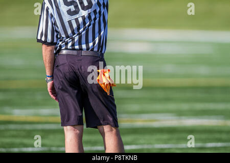 Referee and flag hanging from back pocket. Boys Bantam football in Calgary, Alberta, Canada Stock Photo