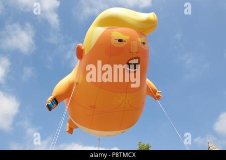 London, UK. 13th July, 2018. Trump baby balloon flying over Parliament Square, Westminster, London, in protest of President Donald Trump’s visit to the UK. The balloon campaign raised almost £18,000 and was given permission for Mayor of London Sadiq Khan to fly. Credit: Dimple Patel/Alamy Live News Stock Photo