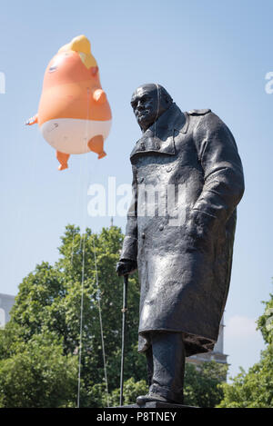 The baby Trump balloon is flying over Parliament Square in London. It is part of the protest against the Trump visit to the UK. Stock Photo