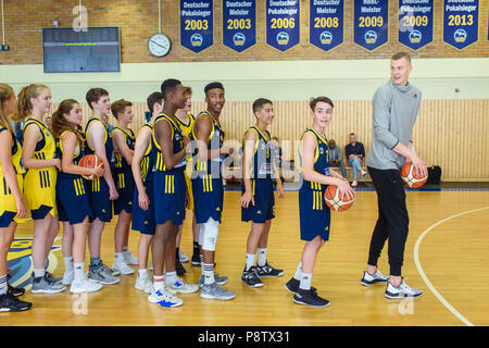 13 July 2018, Berlin, Germany: Kristaps Porzingis (R), power forward of the New York Knicks plays with youth players of the basketball team ALBA Berlin during a joint training session. The Latvian basketball player is currently on an advertising tour in Germany. Photo: Gregor Fischer/dpa Stock Photo