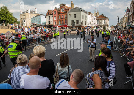 Windsor, UK. 13th July, 2018. Protesters against the visit to the UK of US President Donald Trump outside Windsor Castle, where he is scheduled to meet the Queen for afternoon tea. Protests are expected to be present at all venues in the UK to be visited by the US President and in London and a large policing operation is in place at all protest sites. Credit: Mark Kerrison/Alamy Live News Stock Photo