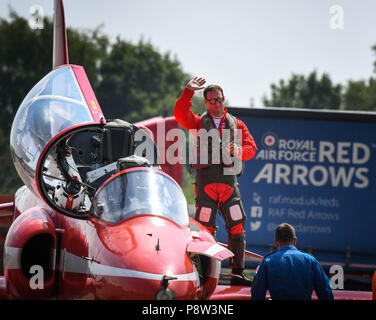 Fairford, UK, 13 July 2018. A Red Arrow pilot acknowledges the crowd after getting out of his jet after another stunning display on the first day of the 2018 Royal International Air Tattoo in Fairford, England (picture taken 13 July 2018) Credit: Ceri Breeze/Alamy Live NewsCredit: Ceri Breeze/Alamy Live News  Stock Photo