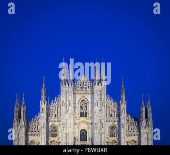 MILAN, ITALY - APRIL 28th, 2018: turists during blue hour taking pictures in Duomo Square , the main landmark of the city. Stock Photo