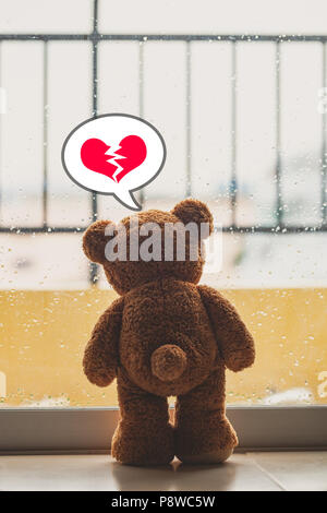 teddy bear Broken heart lonely in the rain. Stock Photo