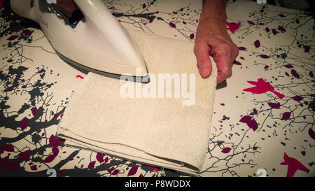 Close-up Of Woman's Hand Ironing Cloth On Ironing Board Stock Photo - Alamy