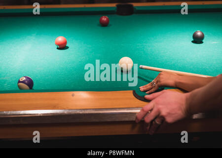 Couple playing snookers in the club Stock Photo