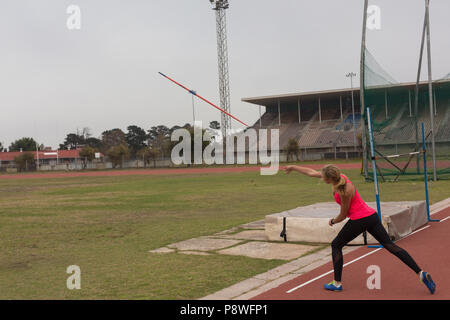 Female athlete practicing javelin throw Stock Photo