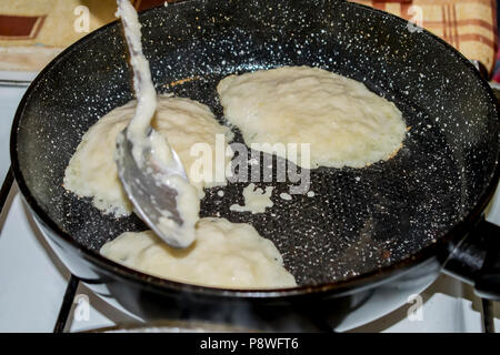 Making pancakes on a cast-iron frying pan Belarus Stock Photo