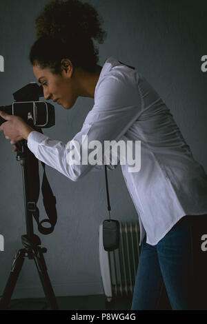 Female photographer clicking photos with digital camera Stock Photo