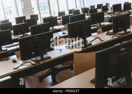 Angled view of classroom with many desktop computers. Stock Photo