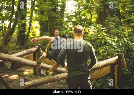 Fit mens training over obstacle course Stock Photo