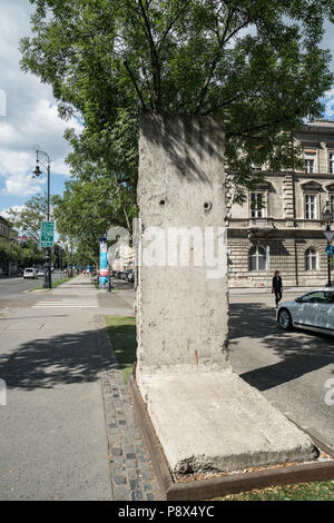view of a piece of the Berlin Wall as a symbol placed in front of the House of Terror in Budapest, Hungary Stock Photo