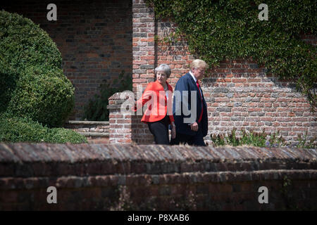 US President Donald Trump walks with Prime Minister Theresa May prior to a joint press conference at Chequers, her country residence in Buckinghamshire. Stock Photo