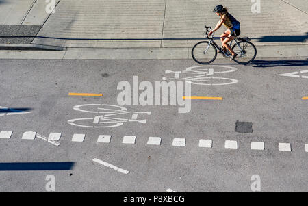Cyclist using dedicated bike lane, Vancouver, British Columbia, Canada.