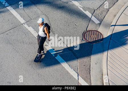 Skateboarding as transportation, Skateboarder on road, Vancouver, British Columbia, Canada. Stock Photo