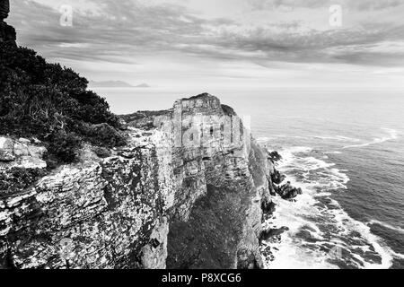 South African rocky ocean coastline along the Cape of Good Hope, South Africa in black and white Stock Photo
