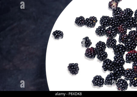 Blackberry on a white table grass background Stock Photo