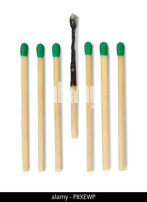 Seven matches one burnt in vertical position against white background. Stock Photo