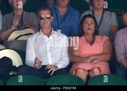 Pierce Brosnan and Keely Shaye Smith in the stands on day eleven of the Wimbledon Championships at the All England Lawn Tennis and Croquet Club, Wimbledon. Stock Photo