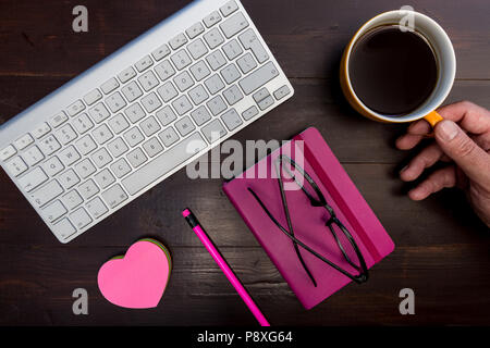 Man working at computer keyboard on wood desk minimal office concept Stock Photo