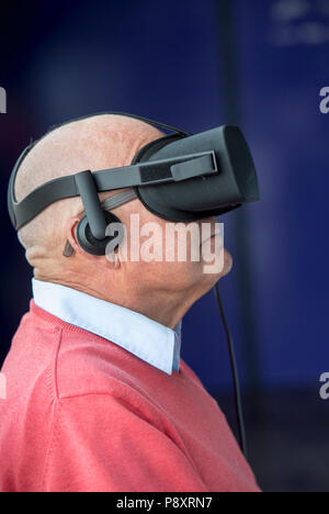 Senior man using a virtual reality headset Stock Photo