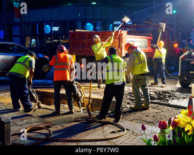 New York City, USA - Apr 2018: Men at work on the street at night in Manhattan Stock Photo