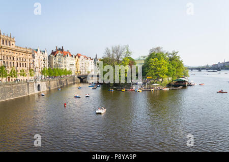 PRAGUE, CZECH REPUBLIC - APRIL 21 2018: Tourist sailing on pedal boats on Vltava river near Charles bridge on April 21, 2018 in Prague, Czech Republic Stock Photo