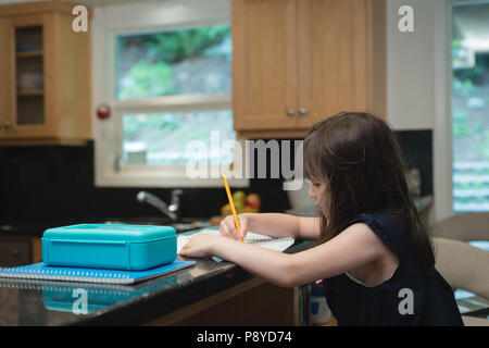 Girl doing homework at home Stock Photo
