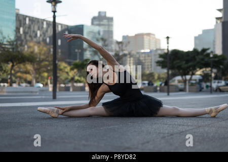 Female ballet dancer stretching before dancing Stock Photo