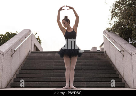 Woman performing ballet in the city Stock Photo