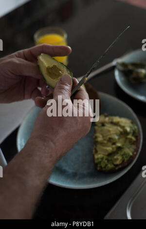 Man preparing breakfast in kitchen Stock Photo