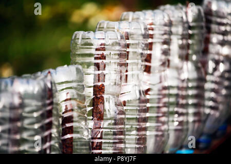 Recycled plastic bottles in a garden Stock Photo