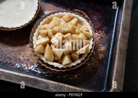 Mini Apple Pie on Baking Sheet, High Angle View Stock Photo