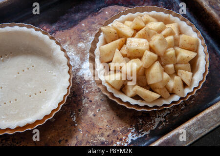 Mini Apple Pie on Baking Sheet, High Angle View Stock Photo