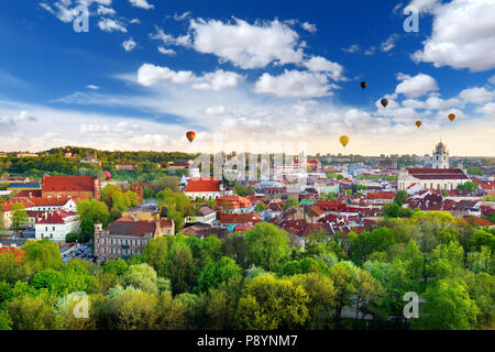 Beautiful summer panorama of Vilnius old town with colorful hot air balloons in the sky, taken from the Gediminas hill Stock Photo