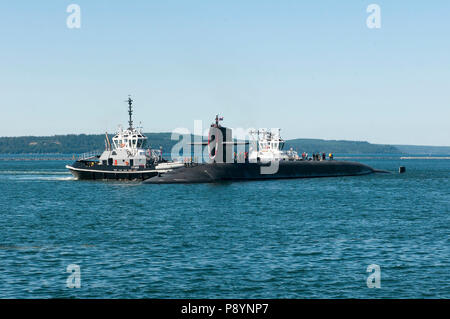 BANGOR, Wash. (July 12, 2018) The Ohio-class ballistic missile submarine USS Nebraska (SSBN 739) returns home Naval Base Kitsap-Bangor following the boats first strategic patrol since 2013. Nebraska recently completed a 41-month engineered refueling overhaul, which will extend the life of the submarine for another 20 years. (U.S. Navy photo by Lt. Cmdr. Michael Smith/Released) Stock Photo