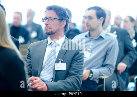 Businessmen listening to spokesman during a business congress business conference Stock Photo