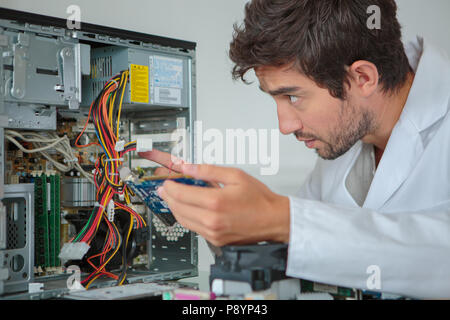 man fix server network in data center room Stock Photo