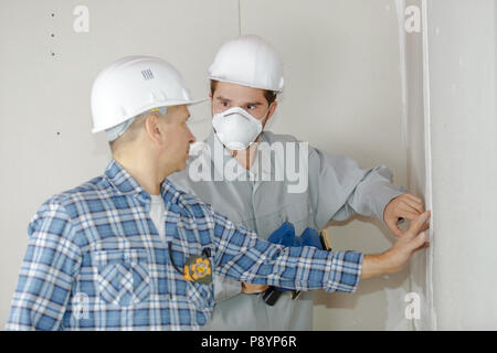 2 technicians working together at a construction site Stock Photo