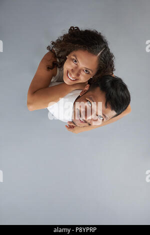 Young smiling couple isolated on gary background. Couple in love Stock Photo