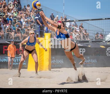 Sara Hughes (USA) digs the ball as Summer Ross (USA) watches at the FIVB Huntington Beach Open on 5 May 2018. (Photo: John Geldermann/Alamy Live News) Stock Photo