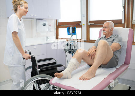 senior patient sitting in hospital waiting for nurse with wheelchair Stock Photo