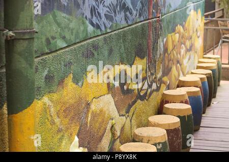 Painted wall background with colored stools (Kunming, Yunnan, China) Stock Photo