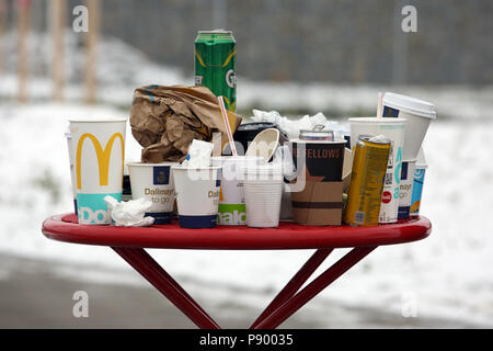 Hermsdorf, Germany, Empty coffee mugs, beverage cans and crumpled paper ducks on a rest area table Stock Photo